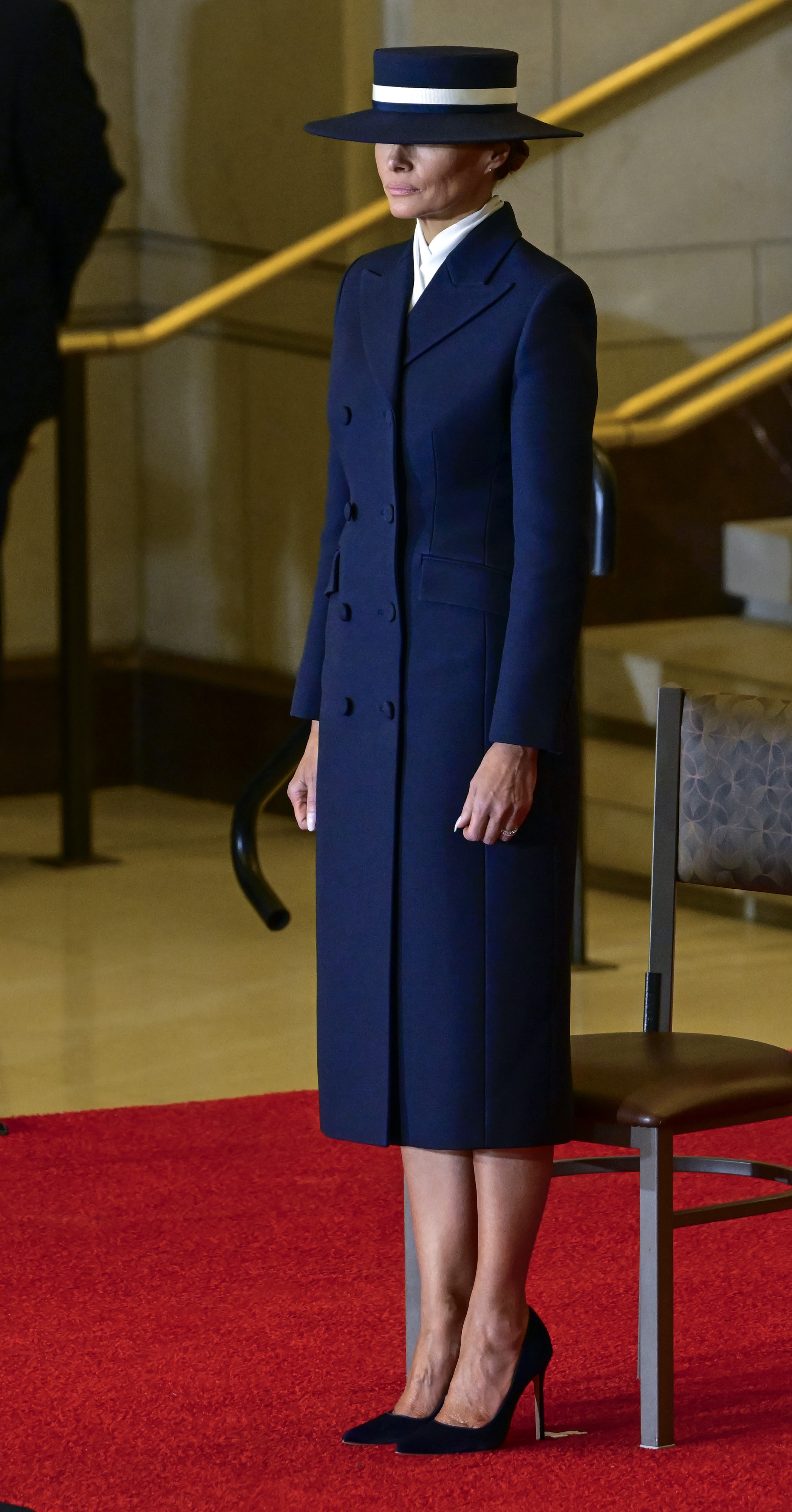 34ec02b33d09e29fd13e0be41b66c52e9e980221a878439d31f5d2112922c716 Melania Trump looking on as Donald Trump participates in a Reviewing the Troops Ceremony. | Source: Getty Images