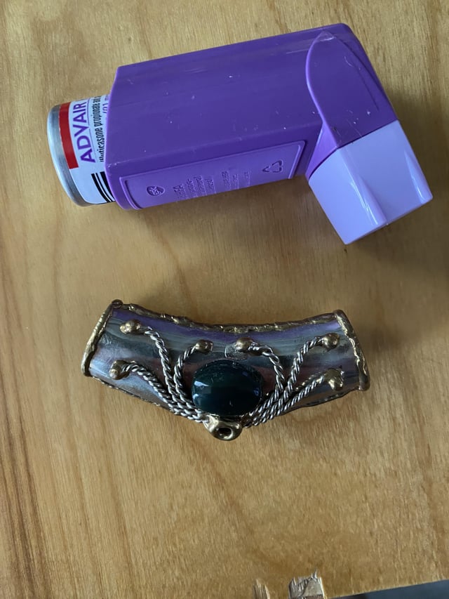 r/whatisthisthing - Found in an old woman's jewelry box. Open at each end and hollow inside. Very light (maybe tin). Inhaler for size.